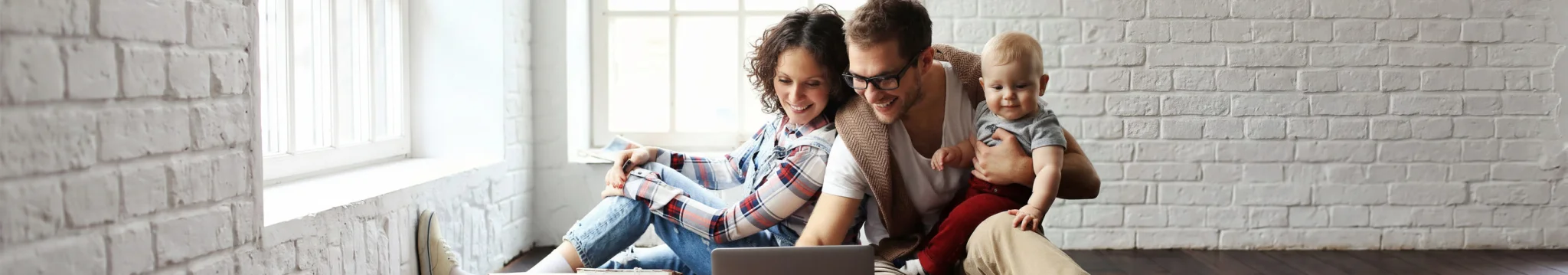 Family using a laptop at home exploring Connecticut Insurance Agency for Home and Auto Insurance Solutions